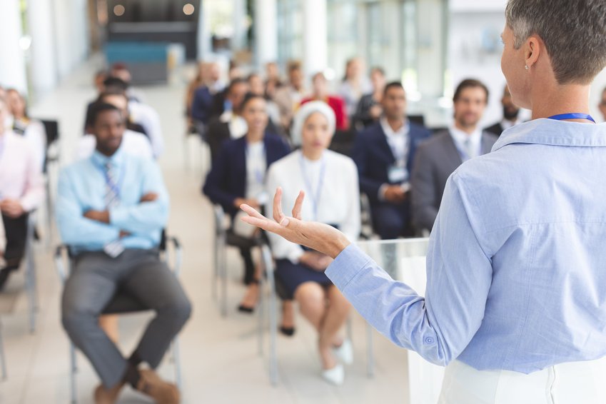 A speaker addressing participants at a professional seminar